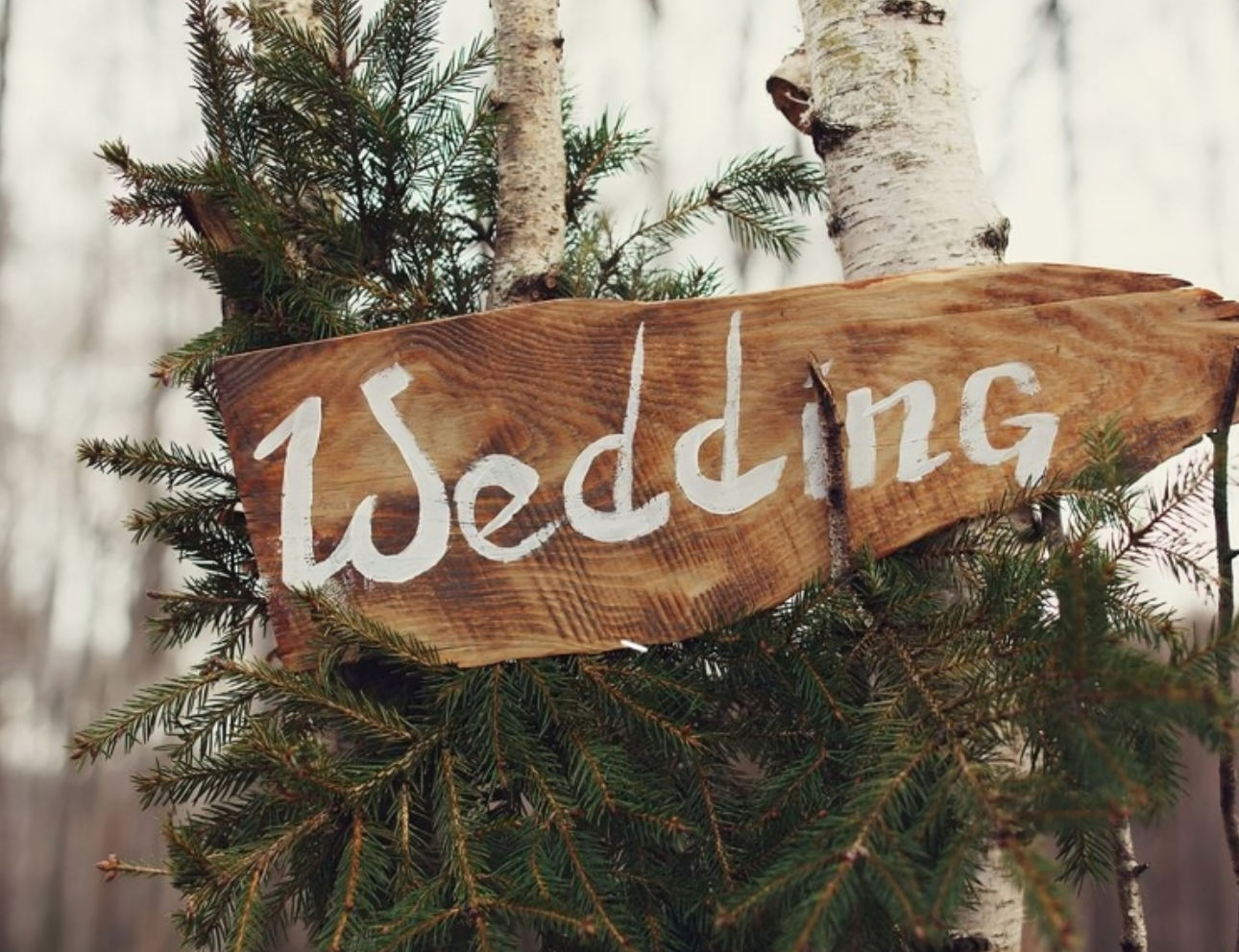 Rustic wedding sign on wooden board.