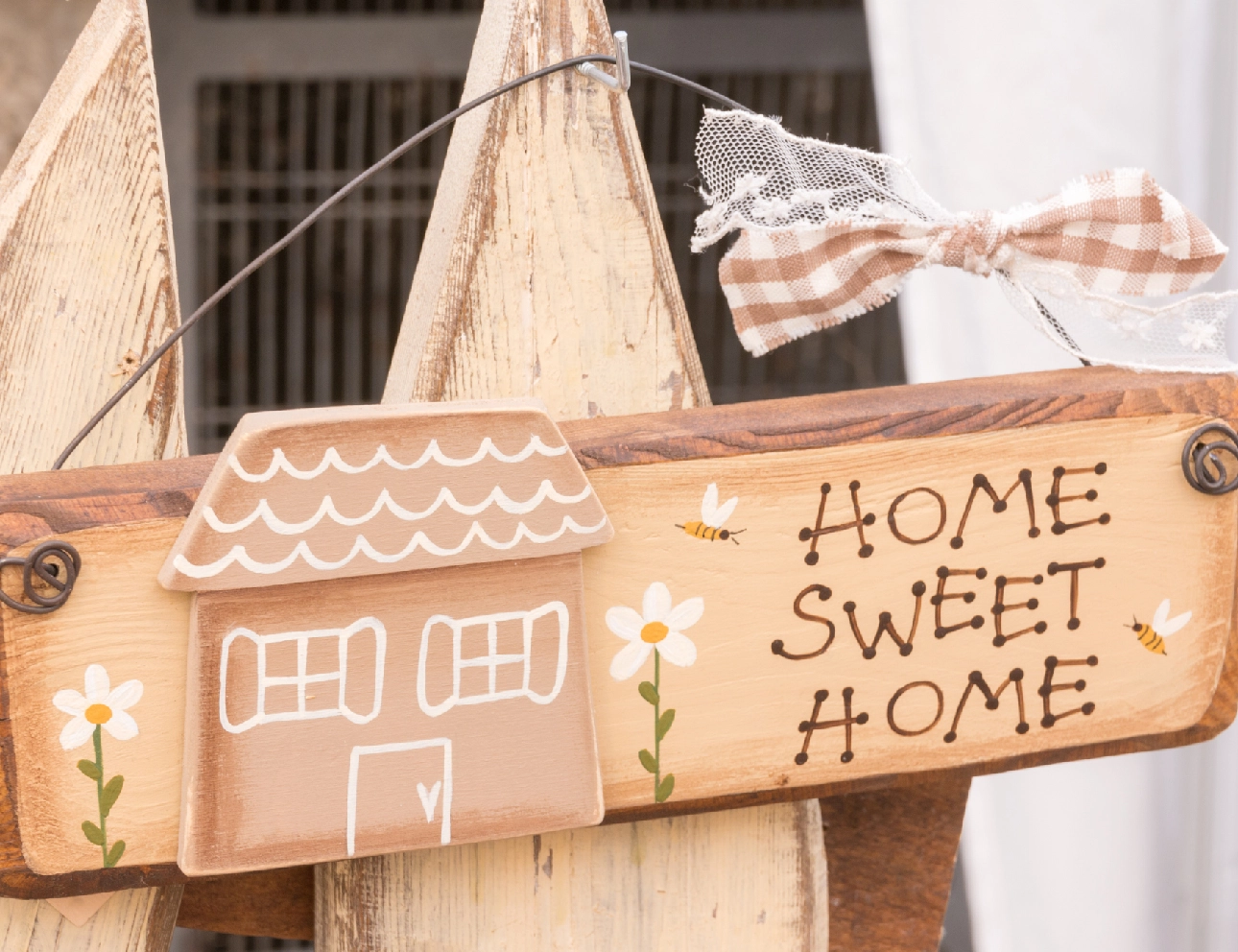 Home Sweet Home" wooden sign with bow.