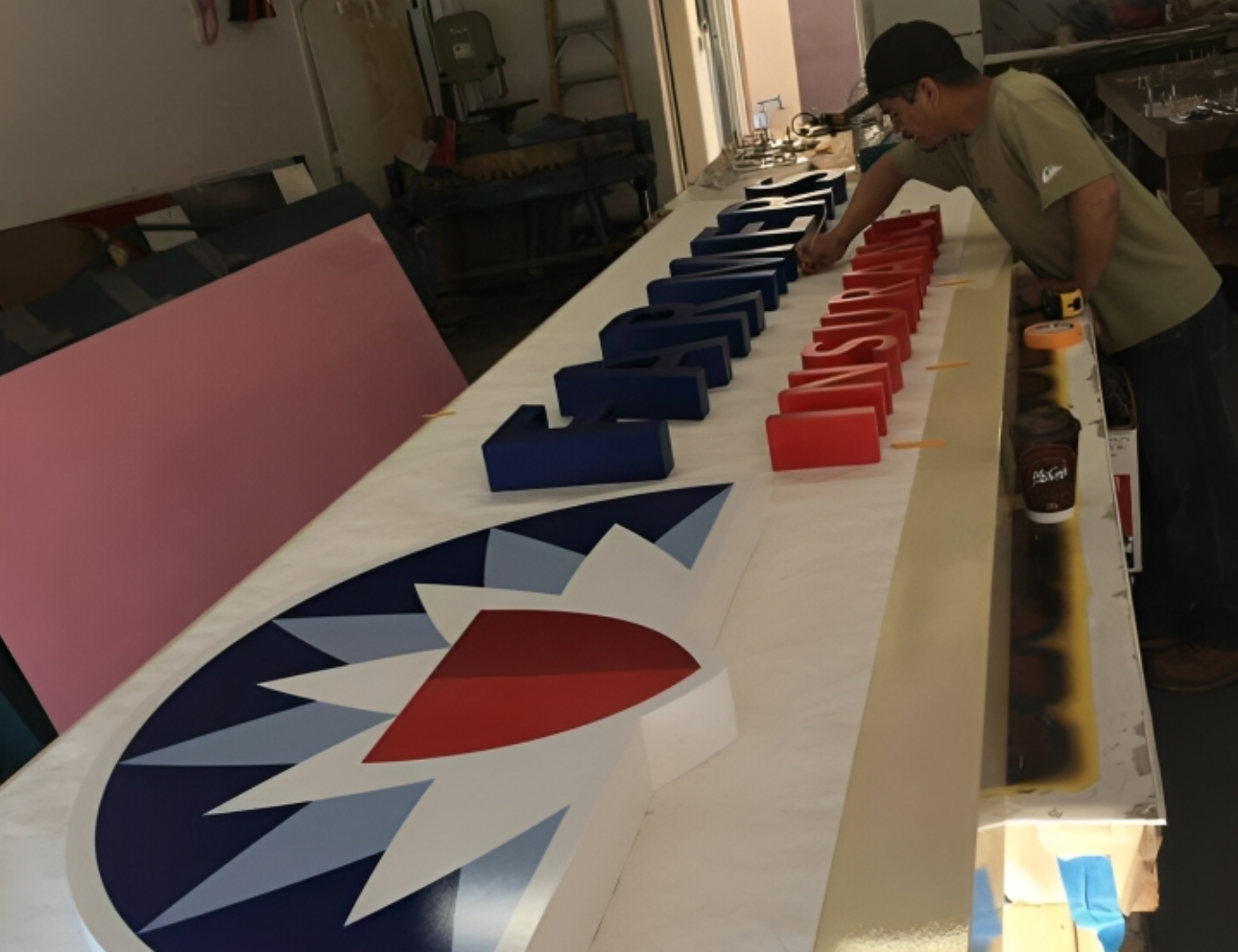 Man assembling colorful 3D sign letters.