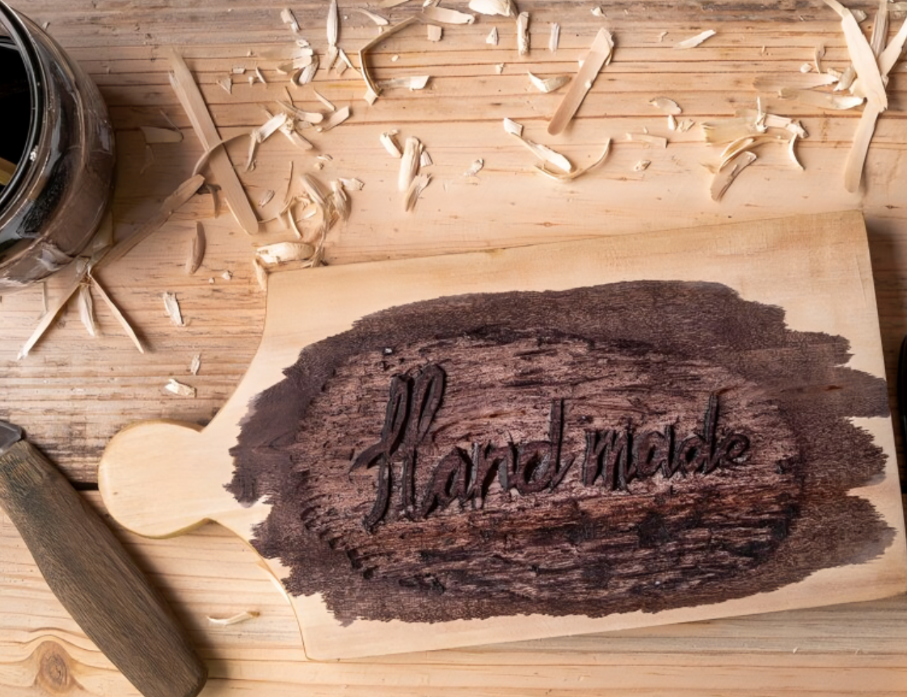 Carved "Handmade" on wooden cutting board.