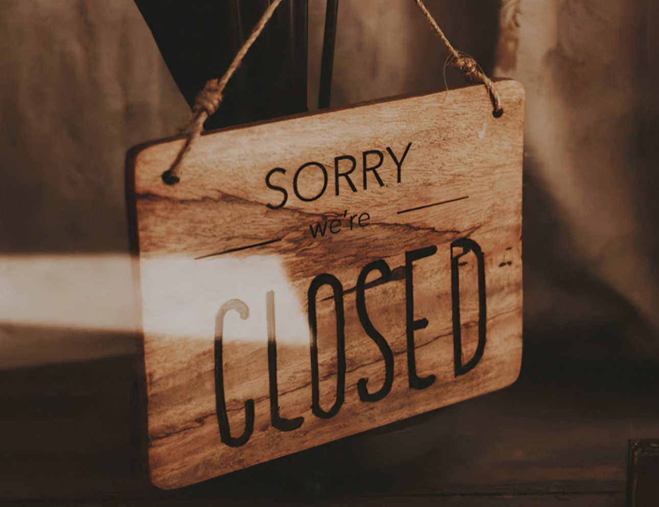 Sorry, we're closed" wooden sign.