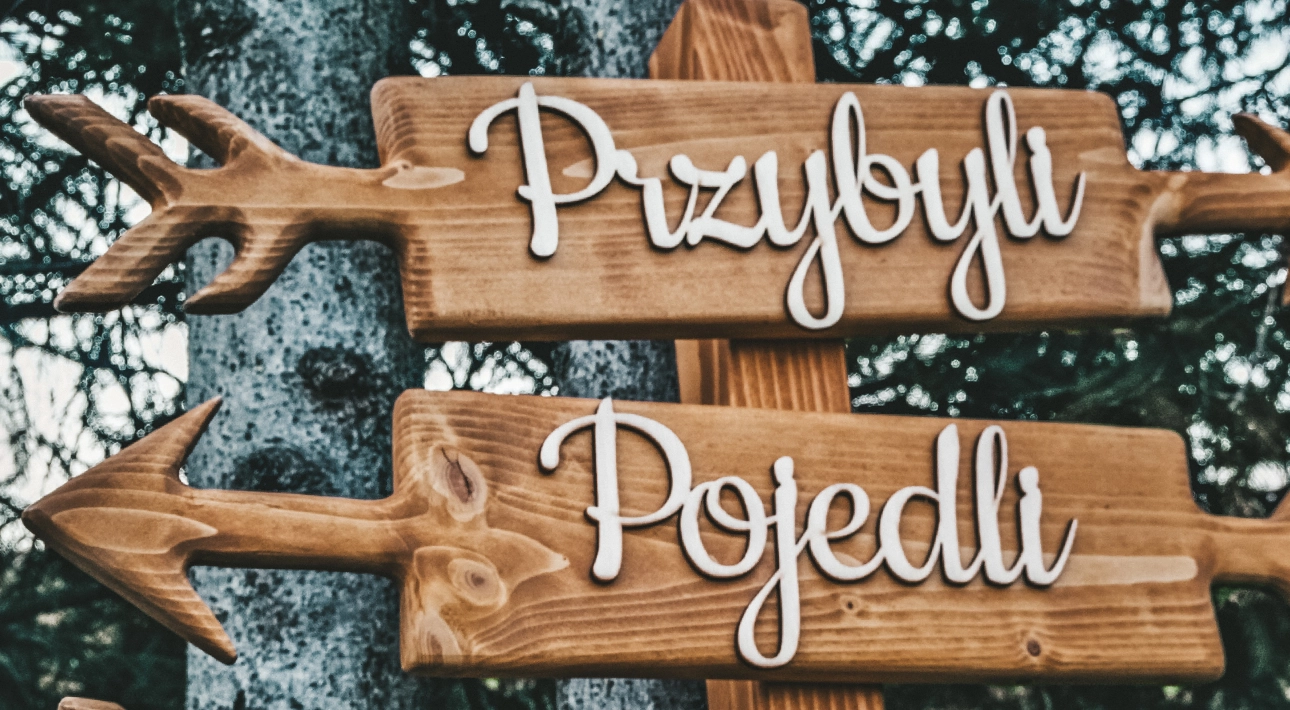 Wooden signs with decorative Polish text.