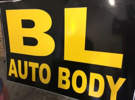 BL Auto Body sign in yellow letters.