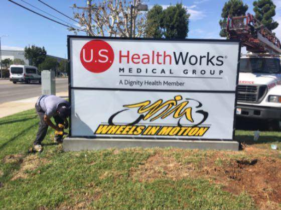 Sign installation for U.S. HealthWorks facility.