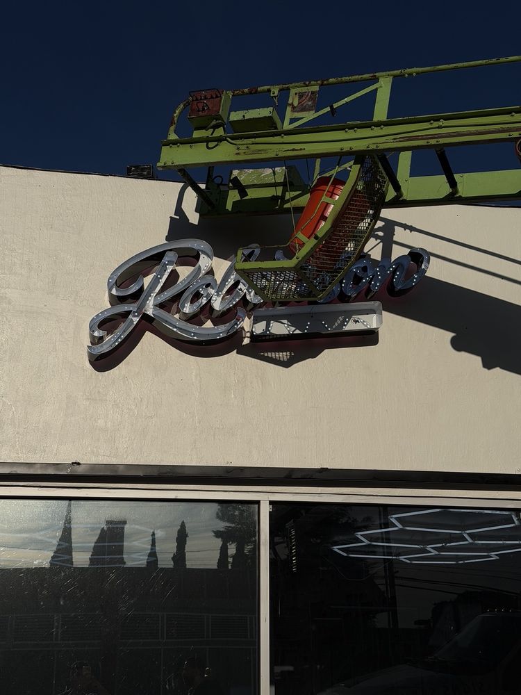 Neon sign installation on building exterior.