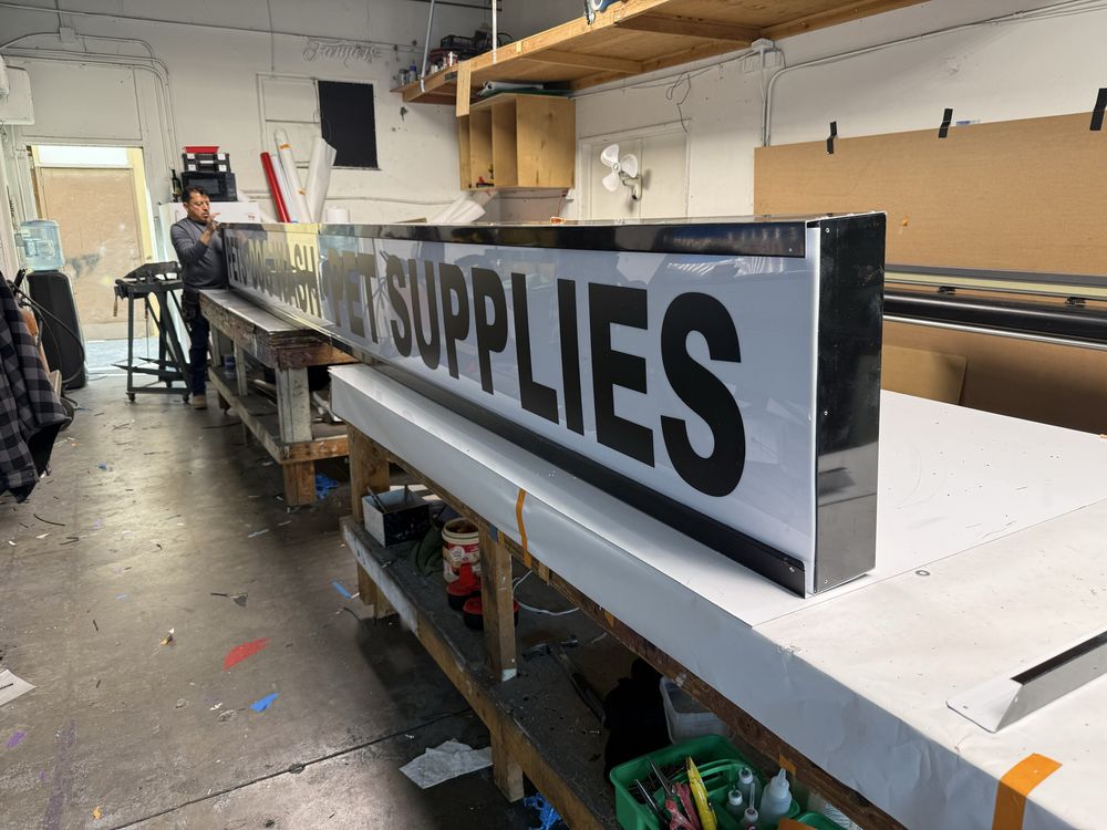 Workshop with large "SUPPLIES" sign in progress.