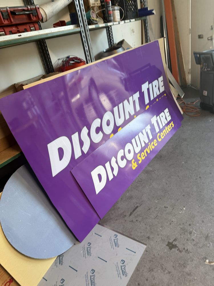 Purple Discount Tire sign in storage area.