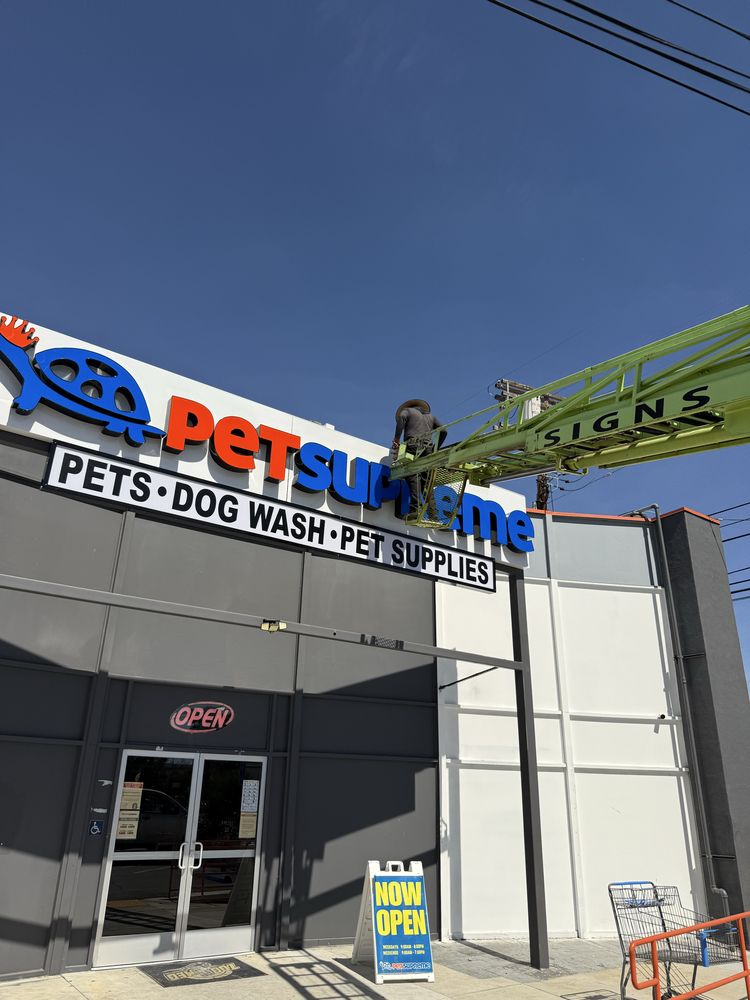 Storefront sign installation for pet supplies store.