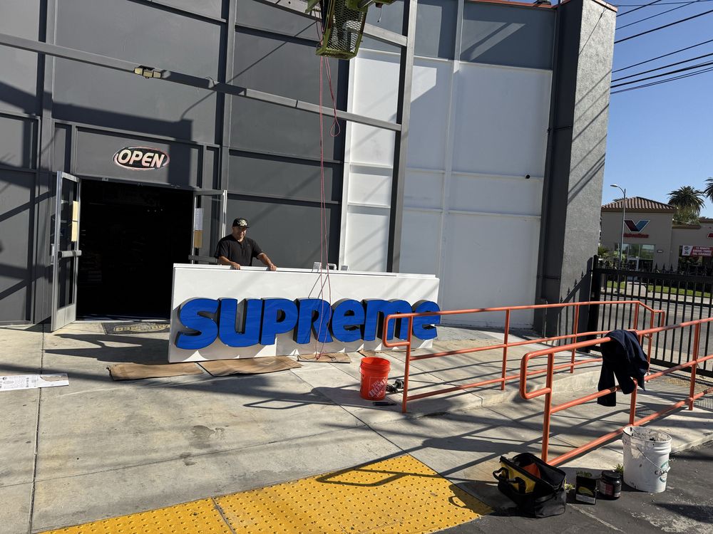 Sign installation outside a store entrance.