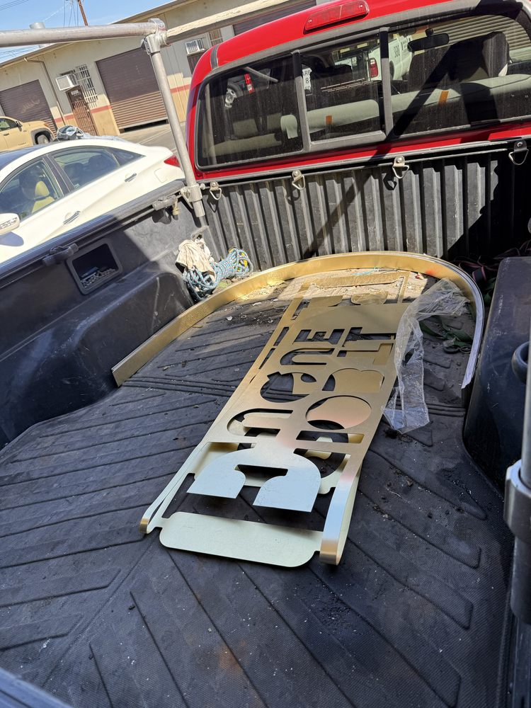 Metal sign in truck bed, outdoor scene.