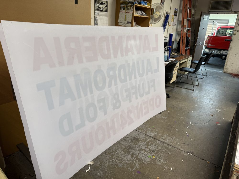 Laundromat sign inside a workshop.