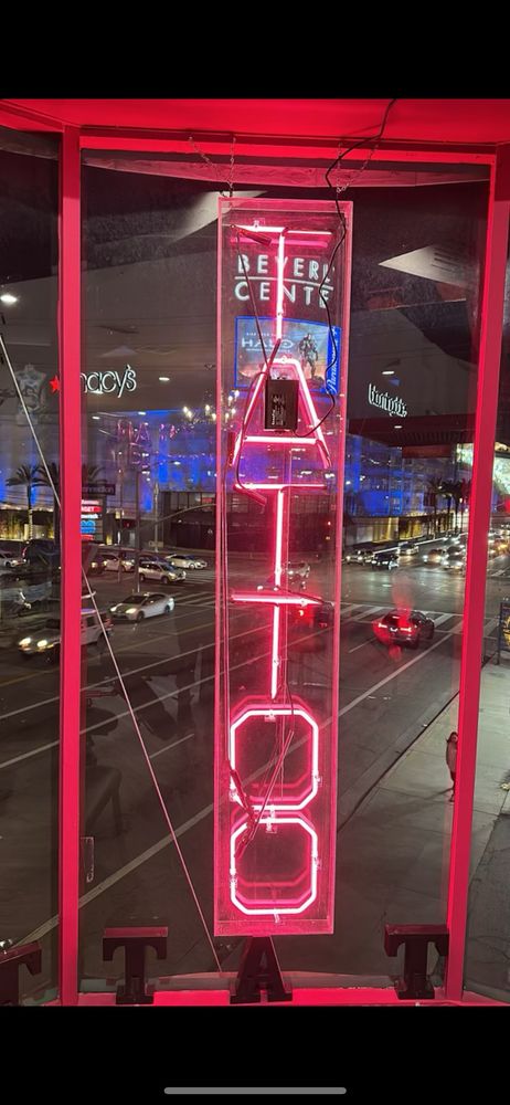 Red neon "Tattoo" sign in window.