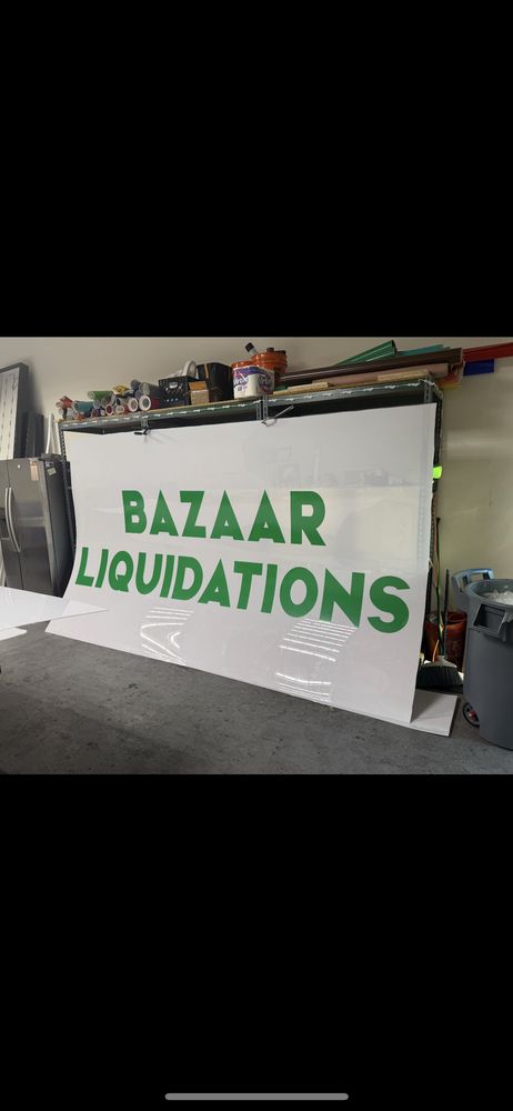 Bazaar Liquidations sign in storage area.