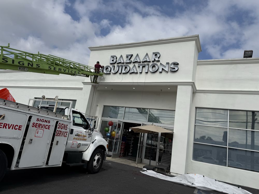 Storefront with sign installation in progress.