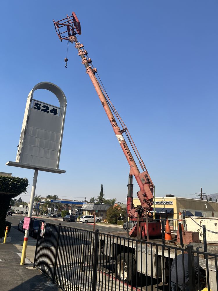 Crane lifting sign in urban area.