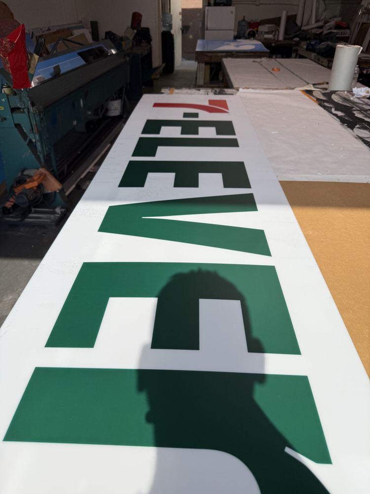 7-Eleven sign in a workshop setting.