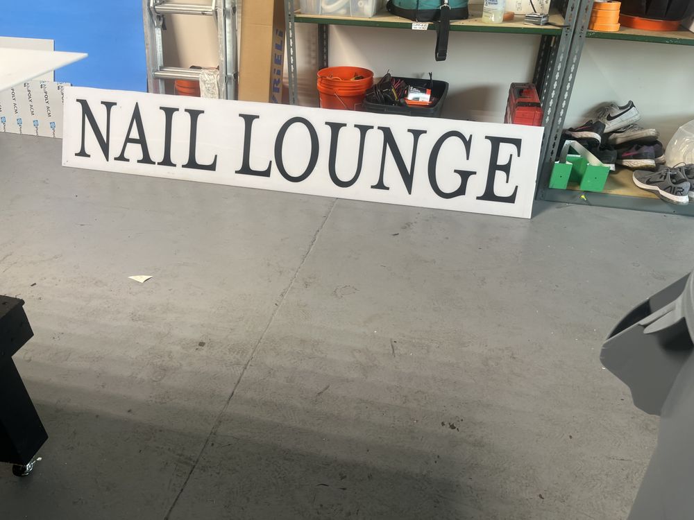 Nail Lounge sign in storage area.