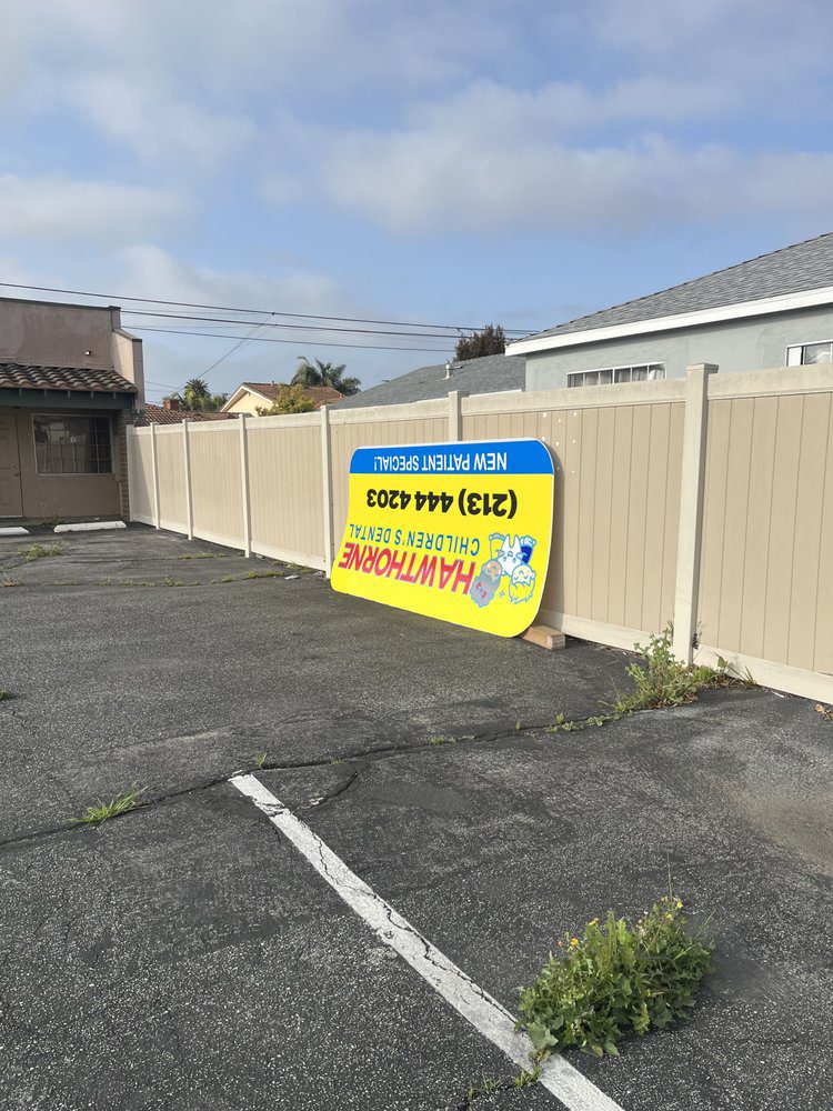 Fallen sign in empty parking lot.