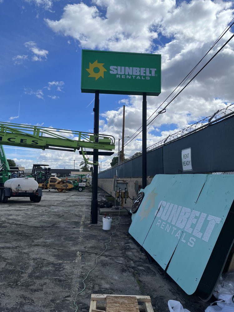Sunbelt Rentals sign in industrial area.