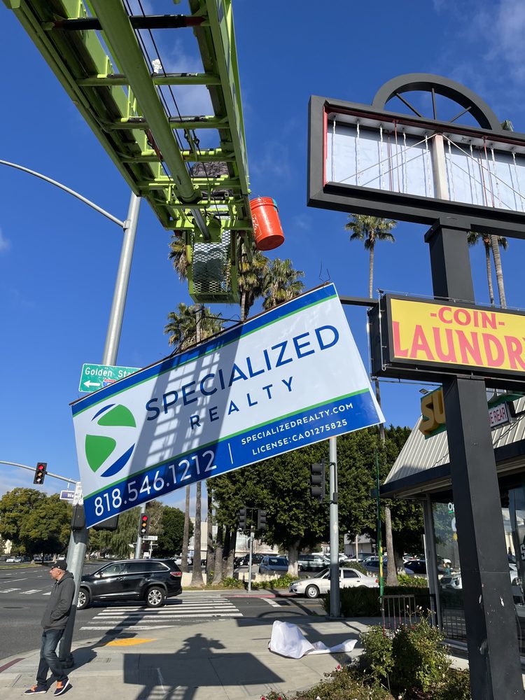 Realty sign installation at street corner.