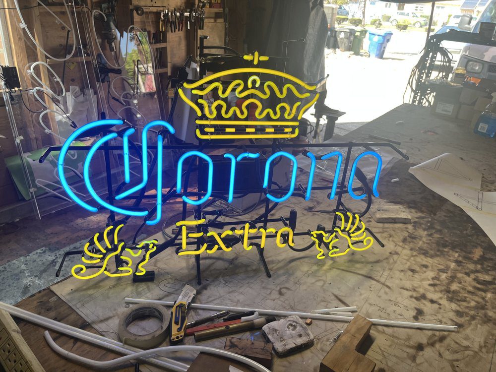 Corona Extra neon sign in workshop setting.