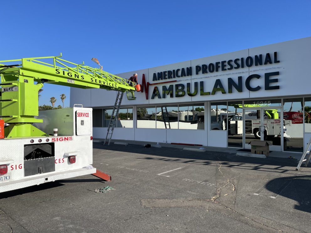 Sign installation at ambulance service building.