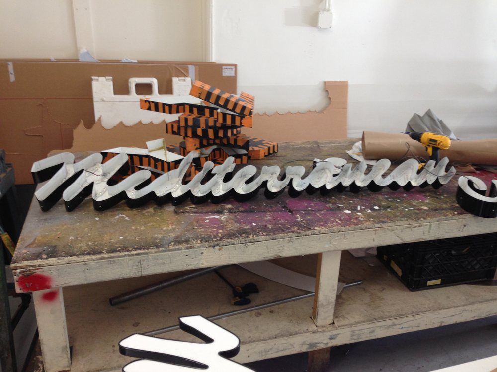 Workshop table with Mediterranean sign in progress.