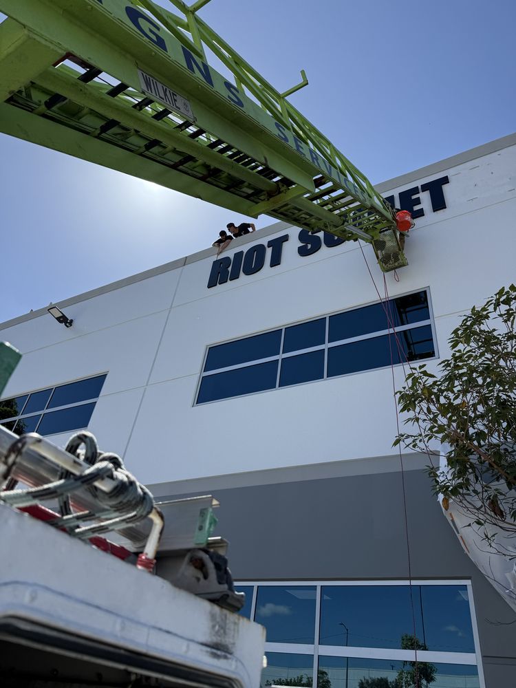 Sign installation on building under clear sky.