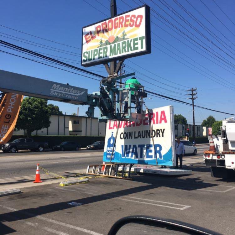 Sign installation at supermarket parking lot.