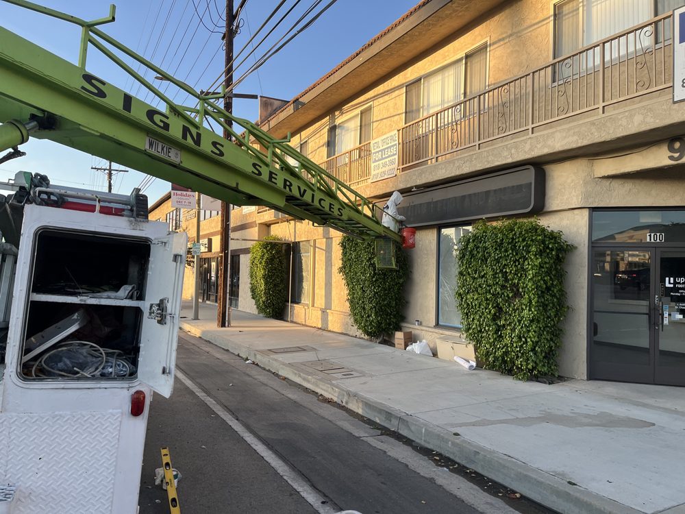 Sign installation on commercial building exterior.
