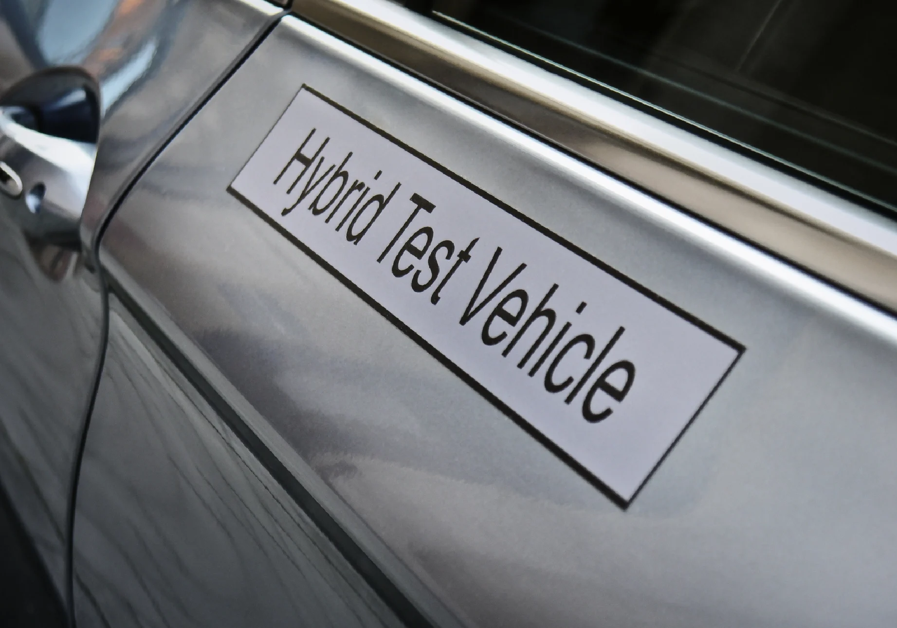 Hybrid test vehicle sign on car door.