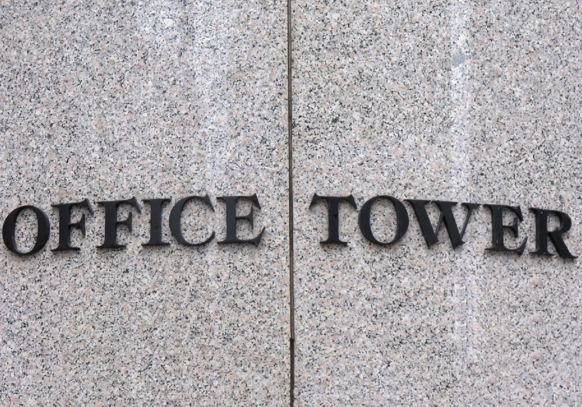 Office Tower sign on stone wall.