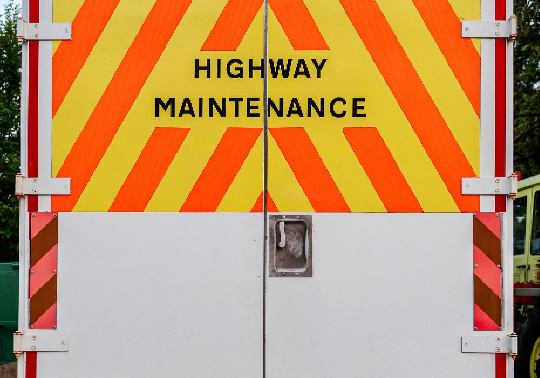 Highway maintenance vehicle with striped pattern.
