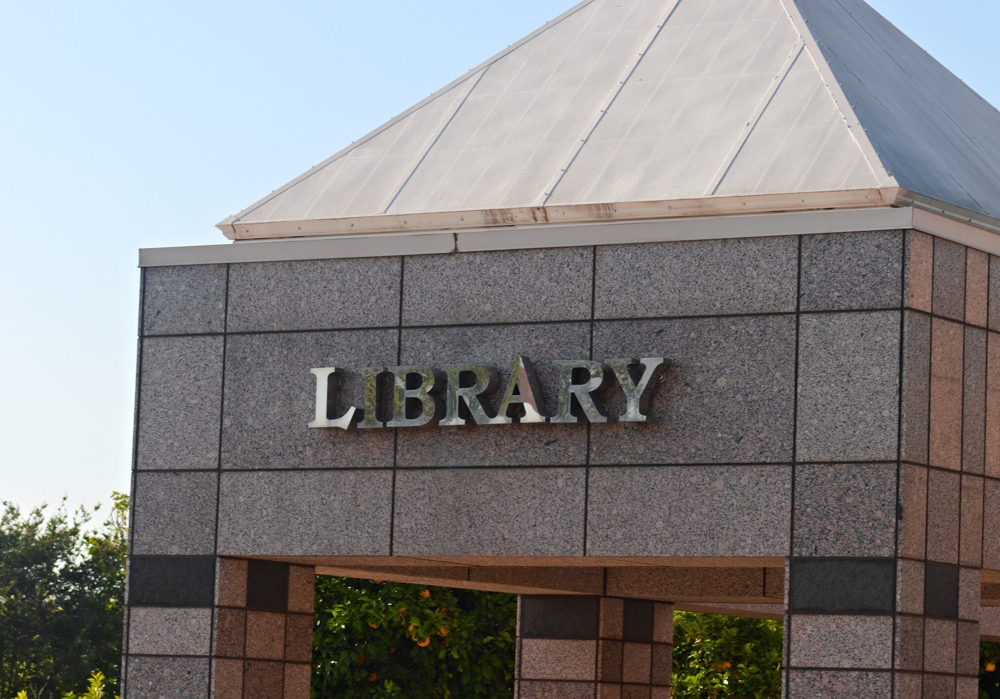 Library building with stone exterior and roof.